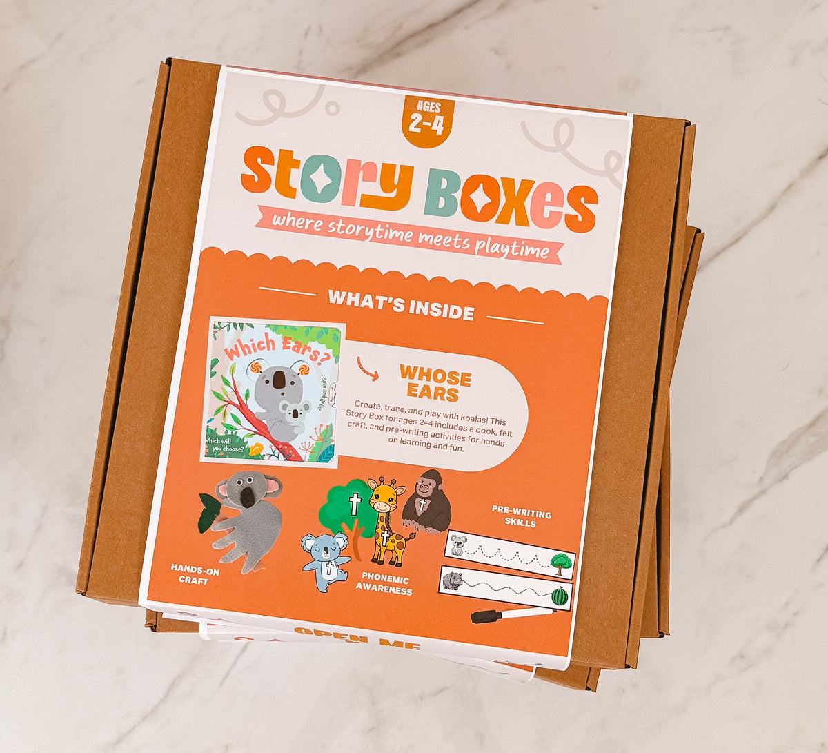Story Boxes packaging with colorful design on a marble surface