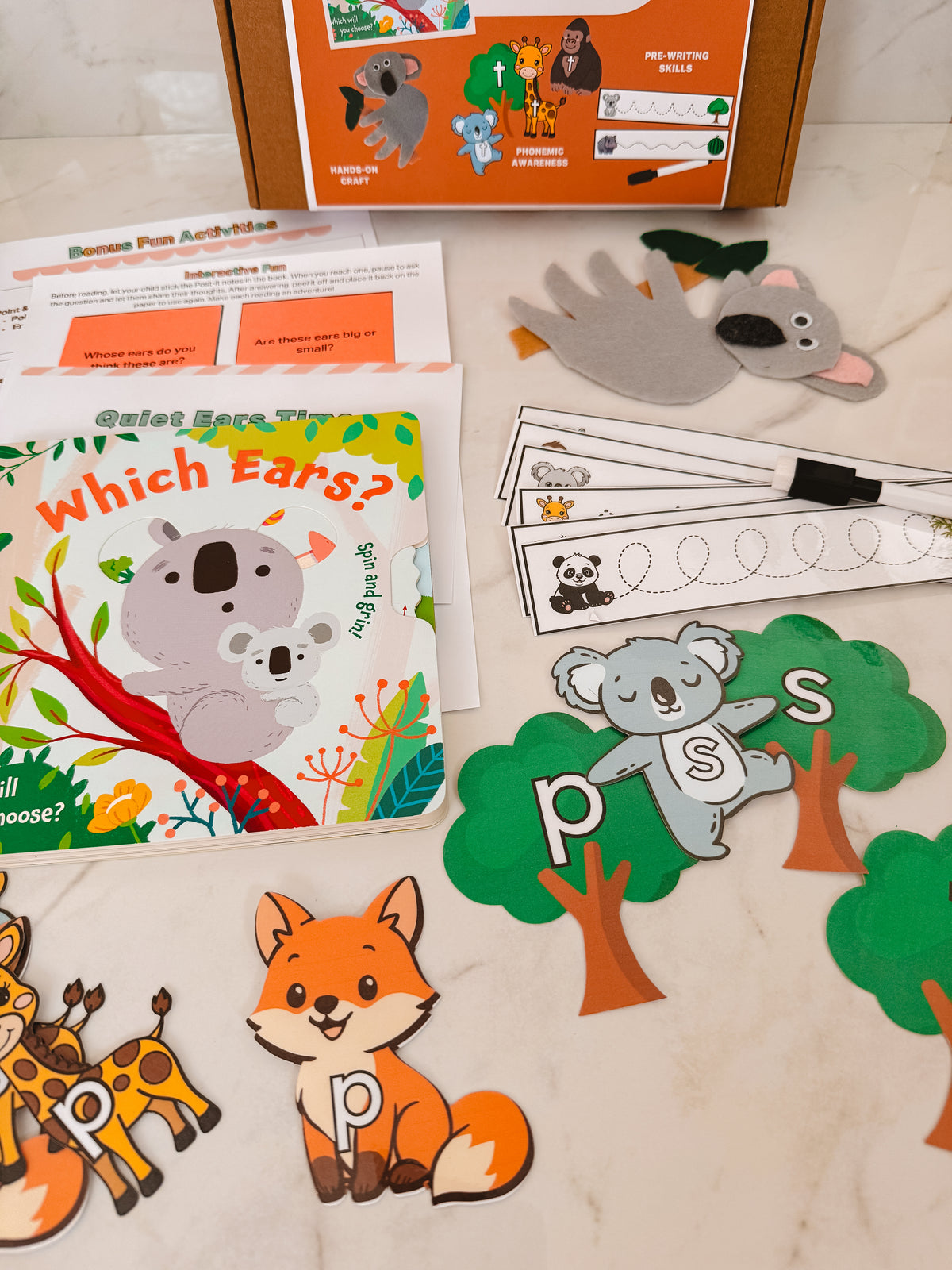 Educational children's materials including a book, puzzles, and flashcards on a table.