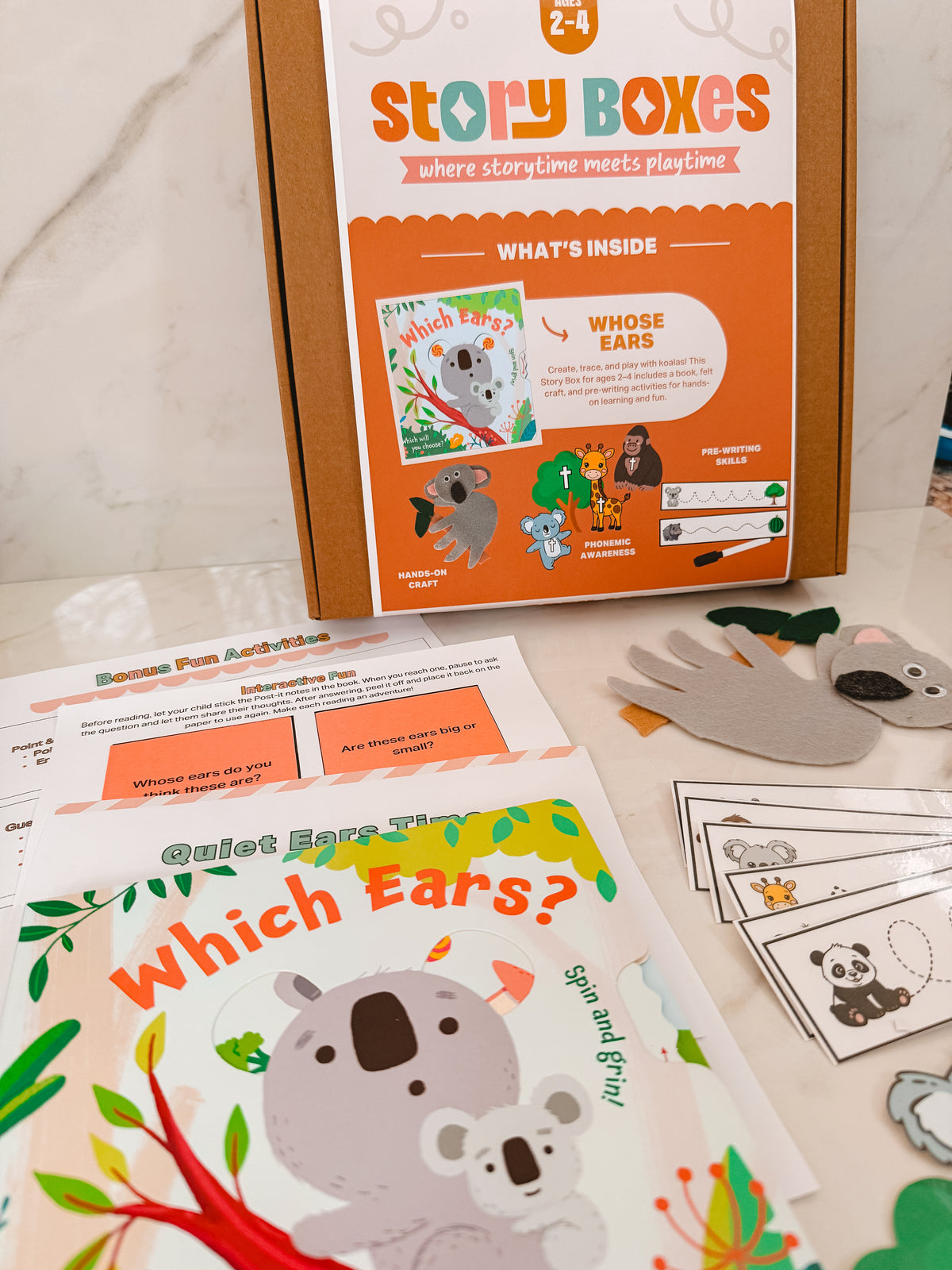 Story Boxes educational kit with children's book and activities on a marble surface